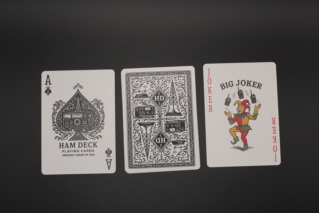 Three playing cards from different decks on a black background