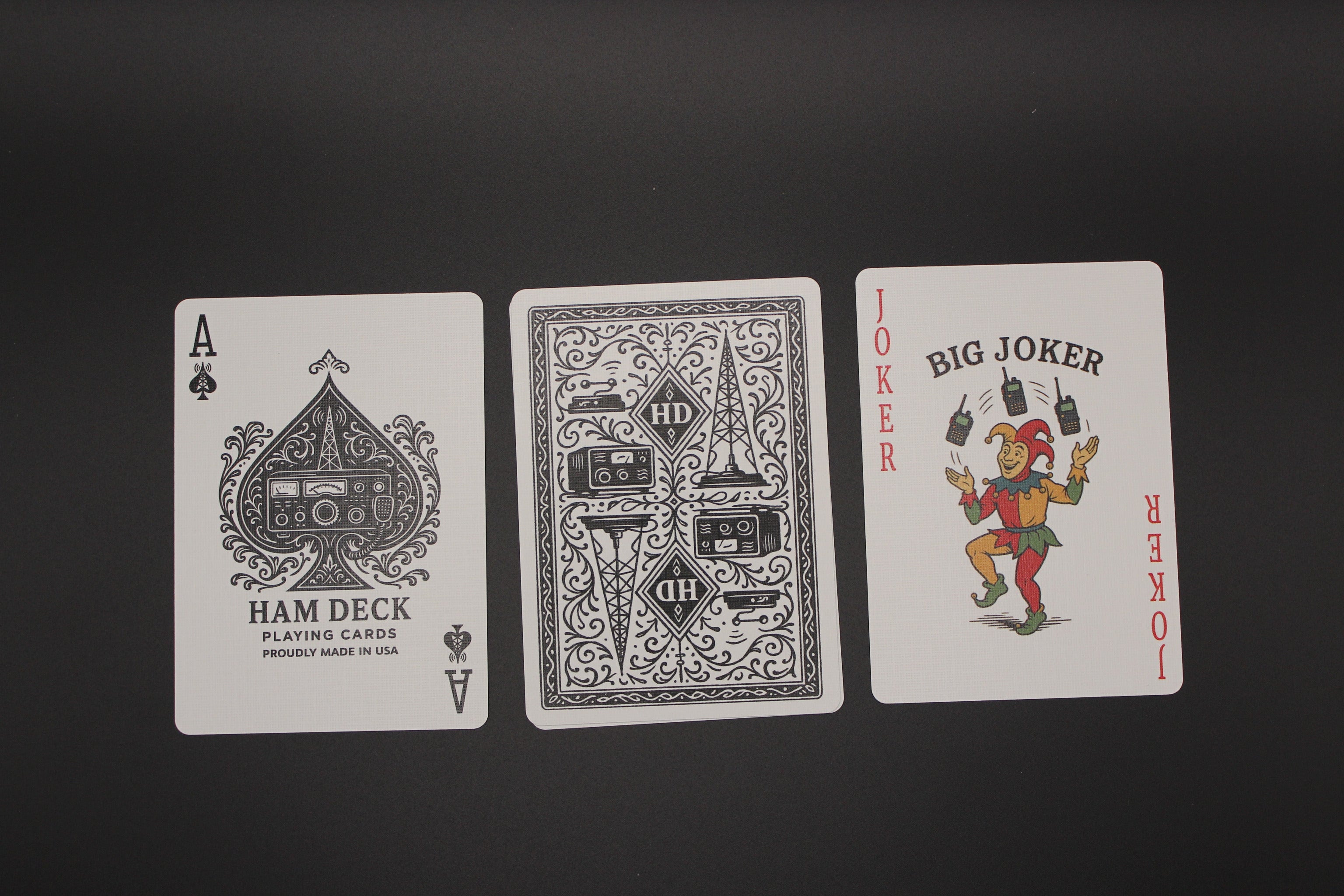 Three playing cards from different decks on a black background