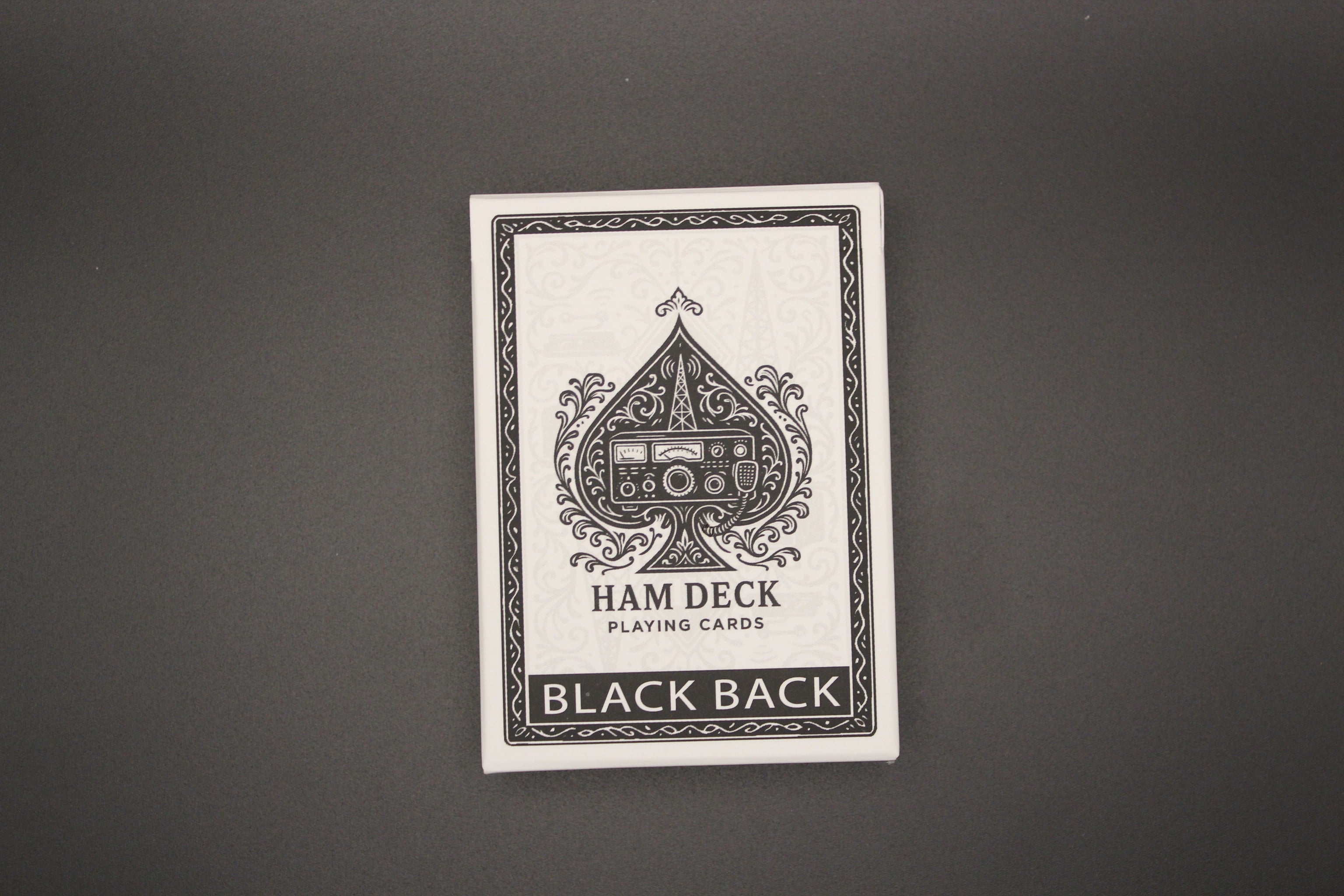 Playing card deck with 'HAM DECK' branding on a gray background