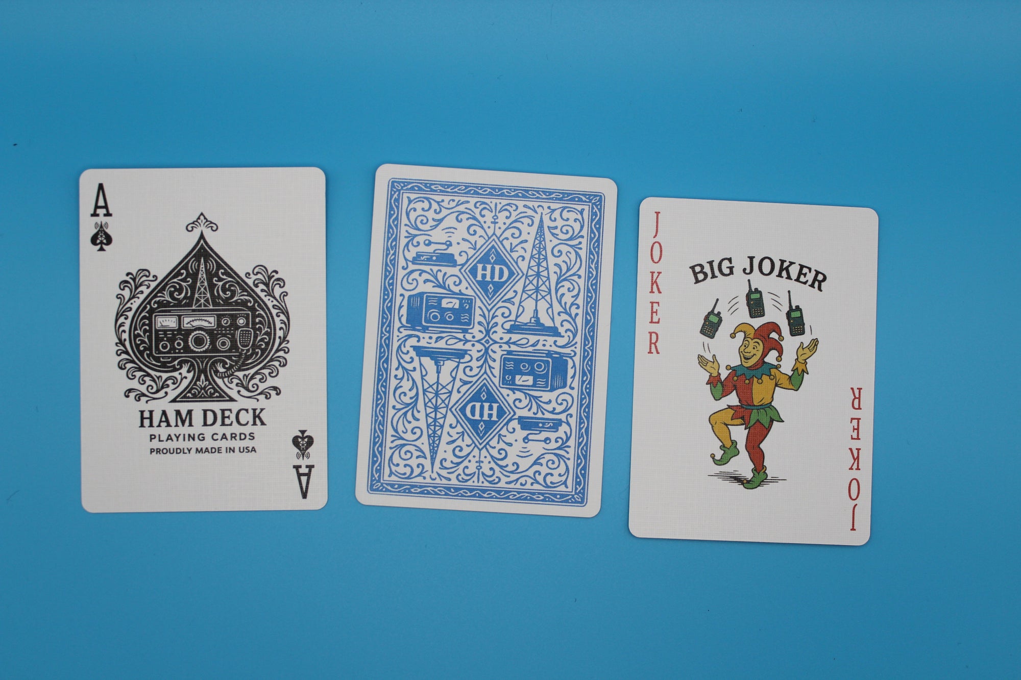 Three playing cards from different decks on a blue background