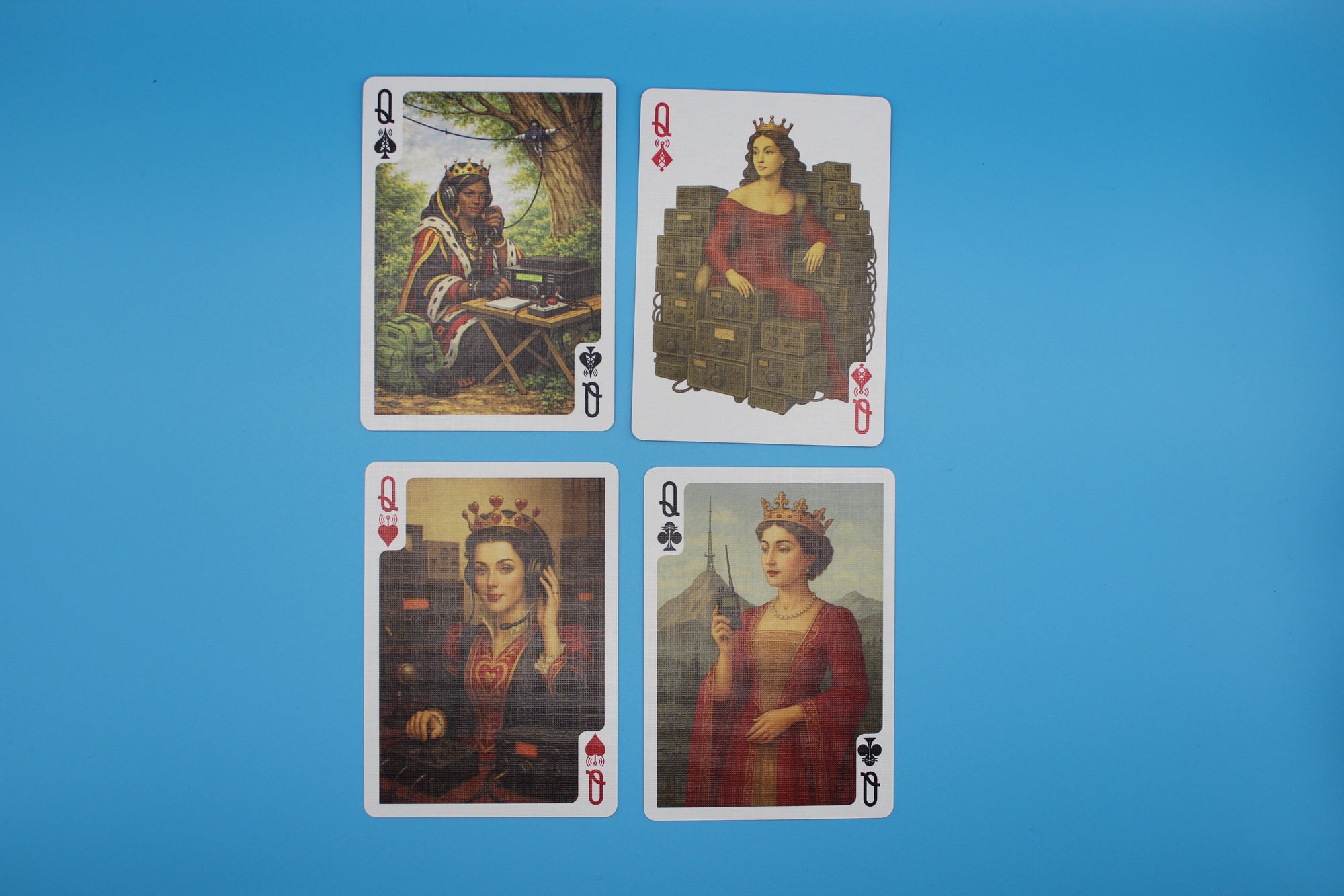 Four playing cards featuring different queens on a blue background