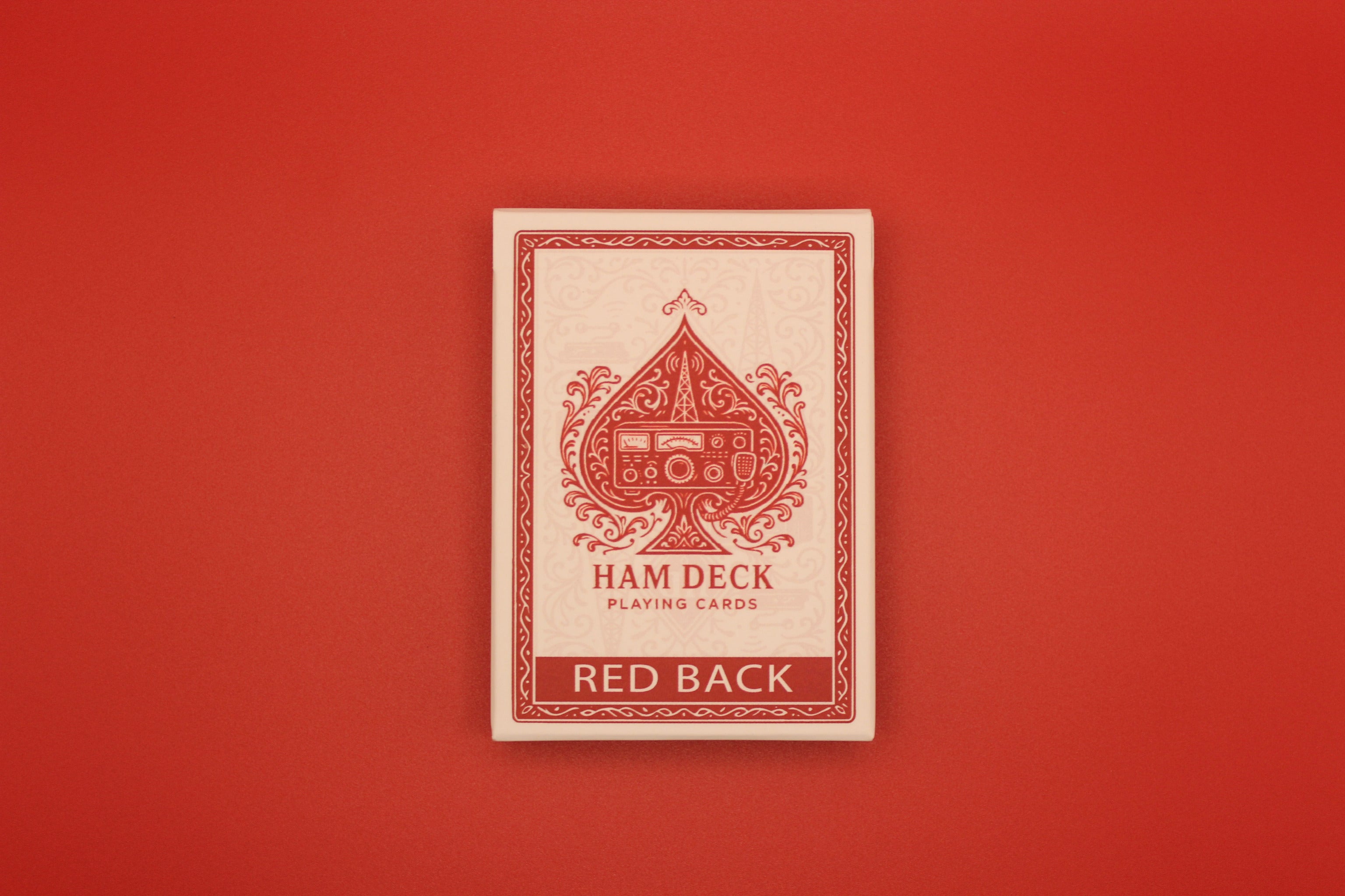 Ham Deck playing card deck with red back design on a red background