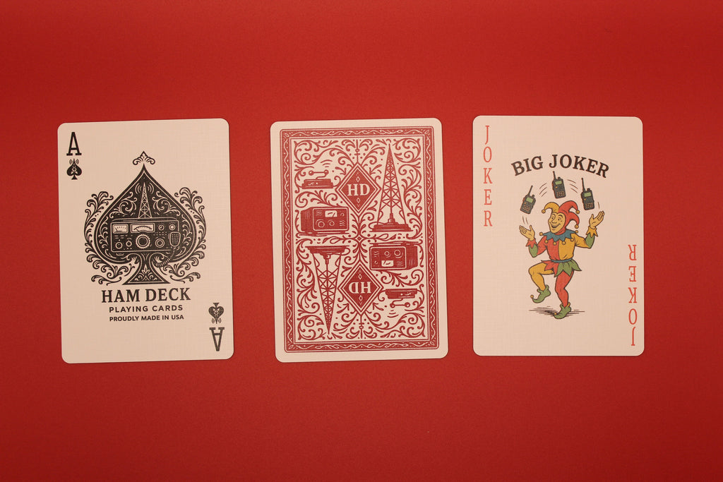 Three playing cards from different decks on a red background